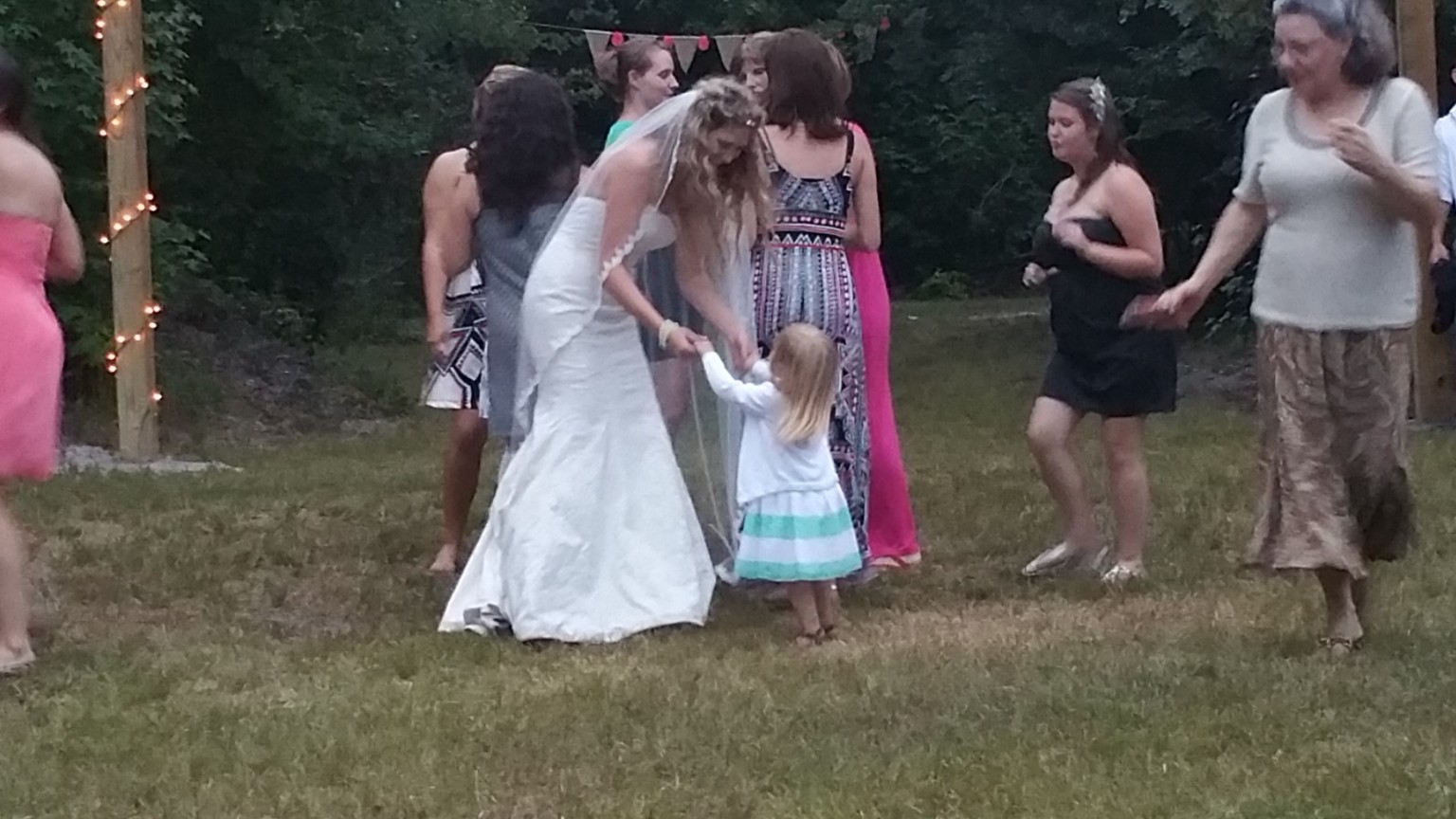 Bride dancing with family and friends